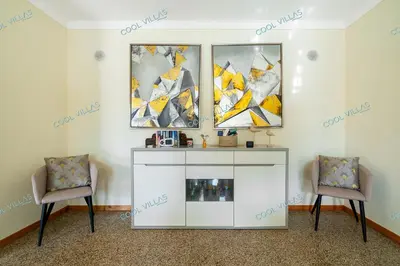 a living room with two chairs and a white cabinet at Villa Cibel - Beach & Golf 10pax in Guia