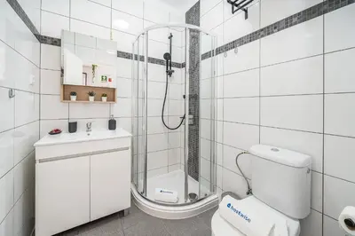 a bathroom with a shower and a toilet and a sink at Sunlit Balcony & Open Space Flat by HostWise in Albufeira