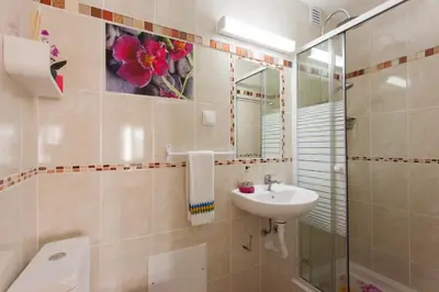 a bathroom with a sink and a toilet and a mirror at Apartamento Cardoso in Albufeira