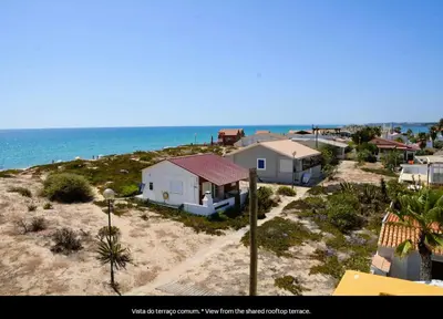 a group of houses on the beach near the ocean at Blife Mariangya private rooms at Faro beach in Faro