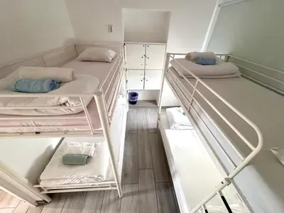 a group of four bunk beds in a room at Blife Sonya private rooms at Faro beach in Faro