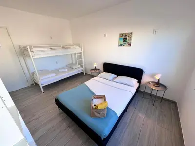 a bedroom with a bed and a bunk bed at Blife Sonya private rooms at Faro beach in Faro