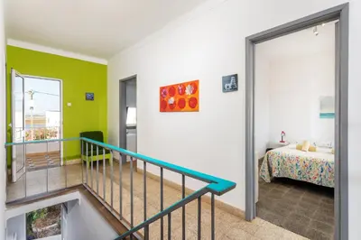 a room with a staircase leading to a bedroom at Blife Troya private rooms at Faro beach in Faro