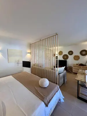 a bedroom with a large bed and a couch at Salgados Studio in Guia