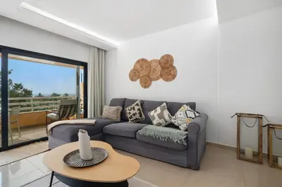 a living room with a couch and a table at Marina Mar in Vilamoura