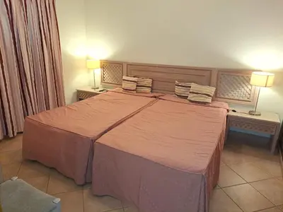 a large bed in a hotel room with two lamps at Superior Two Bedroom Apartment in Clube Albufeira in Albufeira