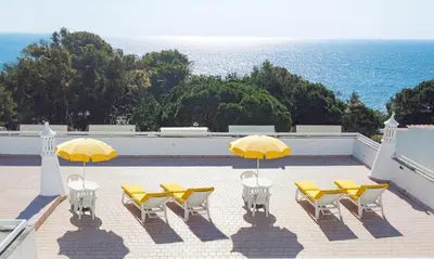 a group of yellow chairs and umbrellas on a roof at Sunflower Apartments by Delilah Collection in Albufeira