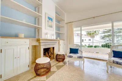 a living room with a fireplace and blue walls at Sunrise Beach Villa by Delilah Collection in Albufeira