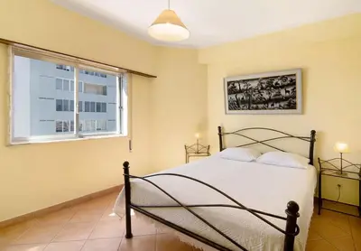 a bedroom with a bed and a window at VIP T2 Beachfront with Garage in Quarteira