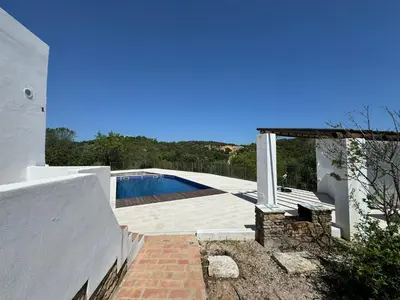 a swimming pool on the side of a house at Quinta do Olival - Casa Faro Oeste - Calm & wellness in São Brás de Alportel