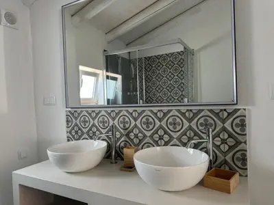 a bathroom with two white sinks and a mirror at Quinta Do Olival - Casa Figueira - Calm & wellness in São Brás de Alportel