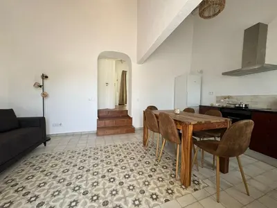 a kitchen and dining room with a wooden table and chairs at Quinta Do Olival - Casa Figueira - Calm & wellness in São Brás de Alportel