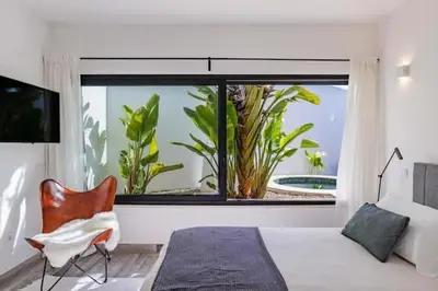 a bedroom with a large window and a bed and a chair at Amazing Views Villa in Loulé