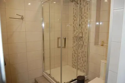 a shower with a glass door in a bathroom at Villa Monte Alegrete with sea view in Faro