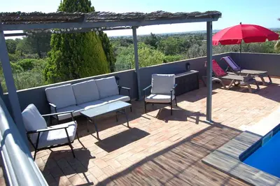 a bedroom with a bed with blue pillows at Villa Monte Alegrete with sea view in Faro