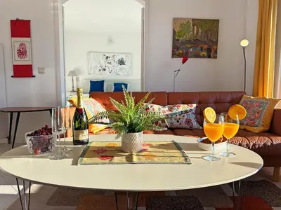 a living room with a table and a couch at WindMill Rooftop Panoramic OceanView Condo By BeCherish in Albufeira