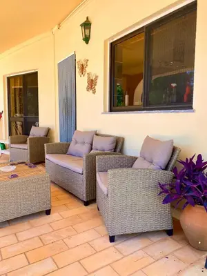 a patio with wicker chairs and couches on a porch at Casa Mariano Private Heated Pool With Views and AC