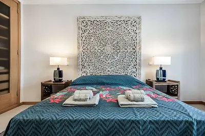 a bedroom with a bed with two towels on it at Villa Gale Coast in Guia