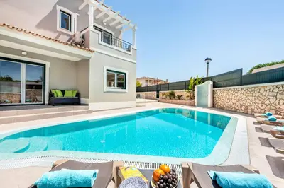a swimming pool in the backyard of a house at Villa Gale Coast in Guia