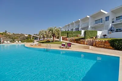 a large swimming pool in front of a building at Terras Novas Albufeira in Albufeira
