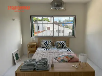 a bedroom with a bed and a window and a table at Casa di Campara Almada Villa in FAO