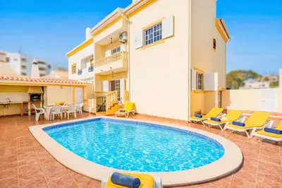 a living room with a blue couch and a table at Villa Atlantis by Algarve Vacation in Guia