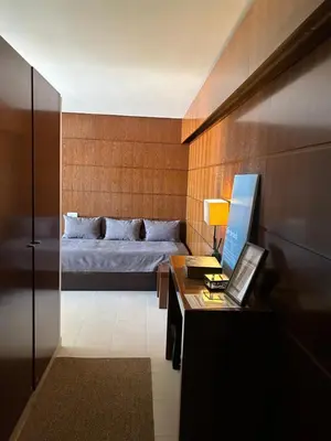 a bedroom with a bed and a desk with a computer at Vila das Lagoas 9A 3D in Guia