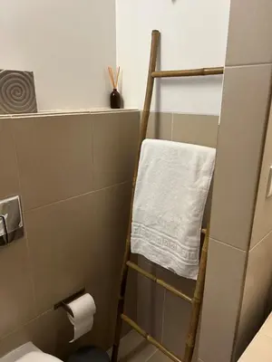 a towel rack in a bathroom with a toilet at Vila das Lagoas 9A 3D in Guia