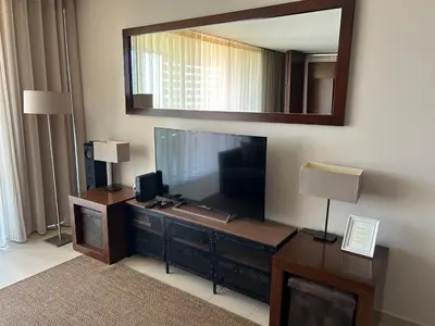 a living room with a large television and a mirror at Vila das Lagoas 9A 3D in Guia