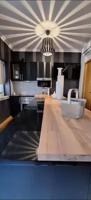 a kitchen with a counter top with a sink at Location la vue sur mer in Albufeira