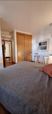 a large bedroom with a large bed and a table at Location la vue sur mer in Albufeira