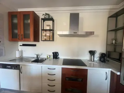 a kitchen with a sink and a stove at Praia Village by Garvetur in Quarteira