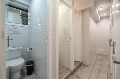 a white bathroom with a toilet and a shower at Blife Sunya private rooms near airport and nature in Faro