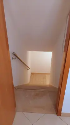 an attic room with a staircase and a stair railing at Casa Balaia in Olhos de Água