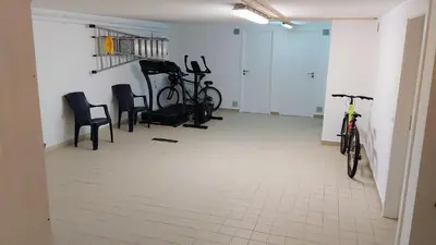 a room with two bikes and chairs in it at Casa Balaia in Olhos de Água