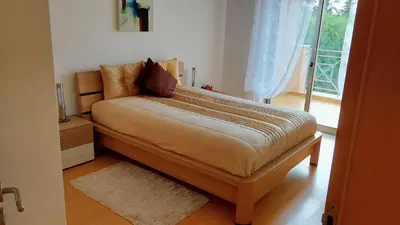 a bed sitting in a room with a window at Casa Balaia in Olhos de Água