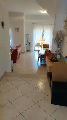 a living room with a couch and a table at Casa Balaia in Olhos de Água
