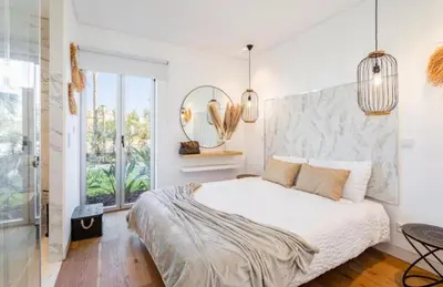 a bedroom with a large bed and a mirror at Miami green in Vilamoura