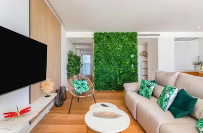 a living room with a couch and a tv at Miami green in Vilamoura