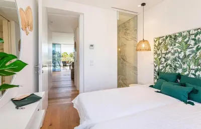 a bedroom with a white bed with green pillows at Miami green in Vilamoura