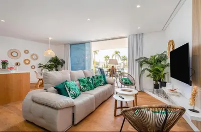 a living room with a couch and a table at Miami green in Vilamoura