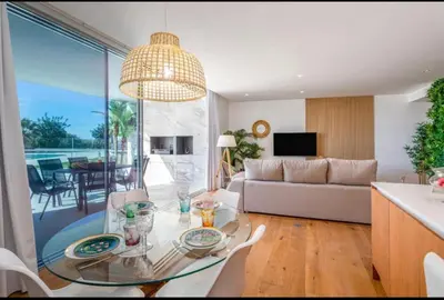 a living room with a glass table and a couch at Miami green in Vilamoura