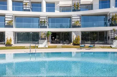 a swimming pool in front of a building at Miami green in Vilamoura