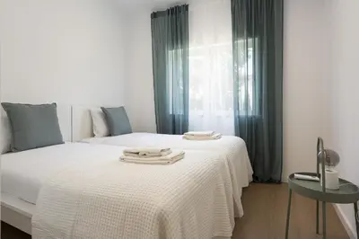 a bedroom with two beds and a window at Alva - cozy apartment with pool by HD in Vilamoura