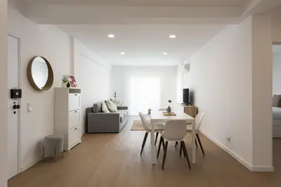 a white living room with a table and chairs at Alva - cozy apartment with pool by HD in Vilamoura
