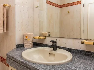 a bathroom with a toilet and a sink and a mirror at Vilamoura Sea View Apartment by Stay ici Algarve Holiday Rental in Quarteira