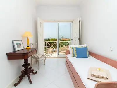 two beds in a room with blue and white at Vilamoura Sea View Apartment by Stay ici Algarve Holiday Rental in Quarteira