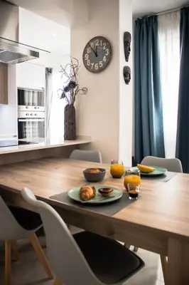 a dining room table with a plate of food on it at Seaside Inspire Wilderness in Quarteira