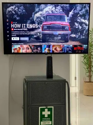 a tv on a wall with a car on it at Seaside Inspire Wilderness in Quarteira