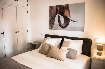 a bedroom with a bed with an elephant painting on the wall at Seaside Inspire Wilderness in Quarteira
